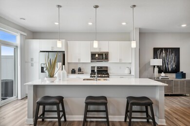 Welcome to the St. Clair! Offering a spacious kitchen with large island, quartz countertops, tile backsplash, white cabinets, pull out trash/recycling cabinet and popular slate finish appliances! *Photos of model home; colors and finishes will vary.