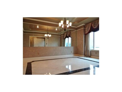 The Formal Dining Room Offers Italian Marble Flooring, a Large Windows For Plenty of Natural Lighting, a Chandelier, Crown Molding & a Recessed Ceiling.