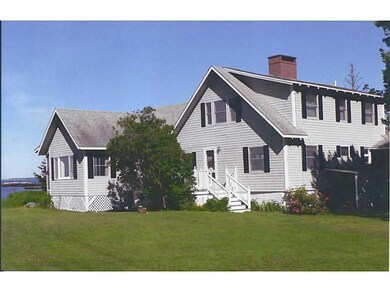 Back of house with expansive lawn...