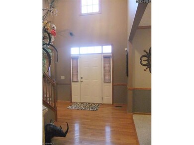 ... a stunning two-story foyer with hardwood floor