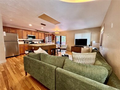 Living room featuring attic access, baseboards, an