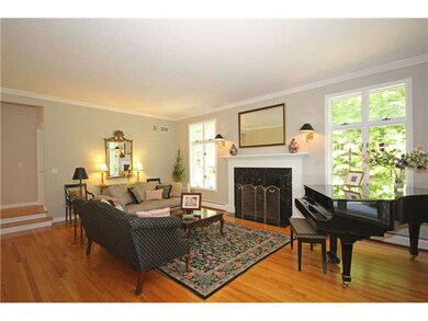 Living Room. To the right of the foyer is the elegant living room with hardwoods, marble surround wood burning fireplace and a 10 foot ceiling height.  A beautiful room for a piano!