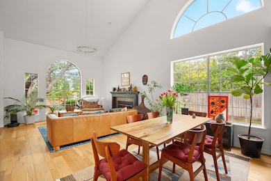 Dining area with high vaulted ceiling, light wood