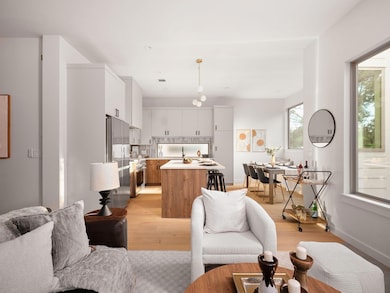Living area featuring light wood-type flooring and baseboards