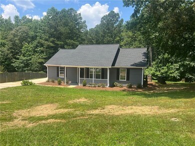 View of front of house featuring covered porch and a shingled roof