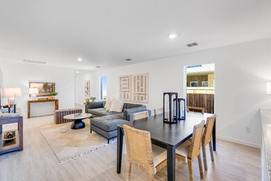 Dining room with light wood-style floors and recessed lighting