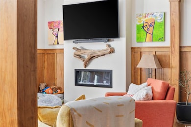 Interior space with a glass covered fireplace and 