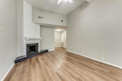 Unfurnished living room with visible vents, a tile