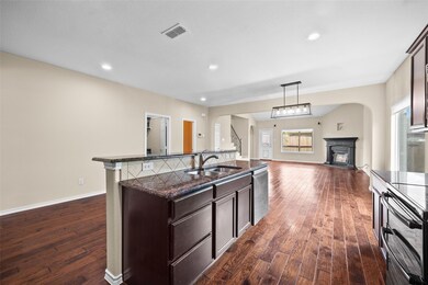 Kitchen featuring a center island with sink, sink,