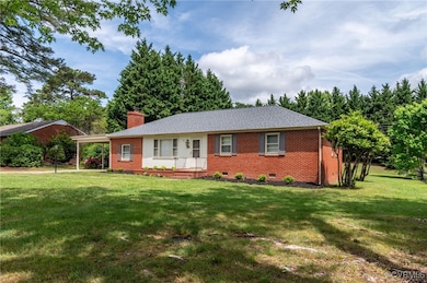 Ranch-style home featuring a chimney, a front lawn