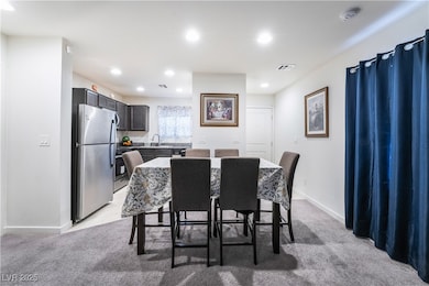 Dining area with visible vents, baseboards, and li
