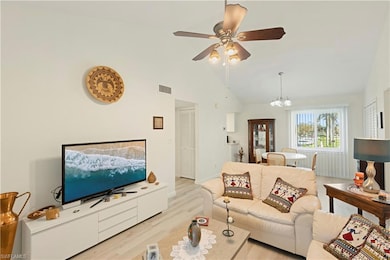Living room with light hardwood / wood-style floor