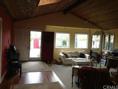 Wide-board hardwood floors, skylight, and sunny fr