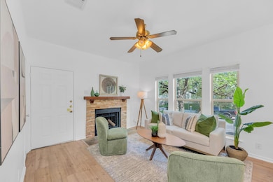 Living area with light wood-style floors, a firep