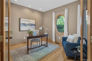 French Doors Open to the Study with Views of the Lush Landscaping in Front of the Home.