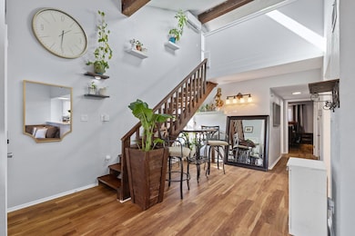 Stairway with beamed ceiling, wood finished floor