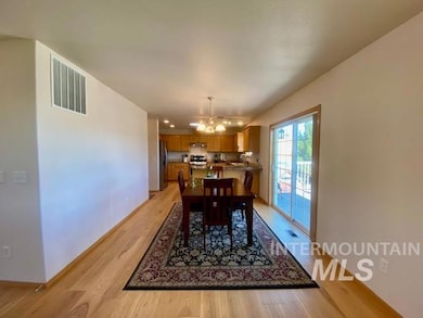 Dining area featuring light wood-style floors and a chandelier