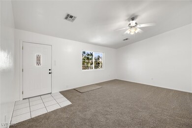 Foyer featuring baseboards, a ceiling fan, carpet