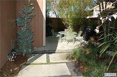 Outside-side sitting area. patio and lush low main