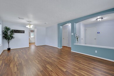 Bright and spacious living area with wood look flo