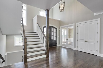 Grand entrance with beautiful hardwood flooring, high ceilings, 5-piece crown molding and an open welcoming feel.