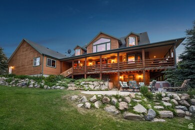 Back of house with a patio and a lawn