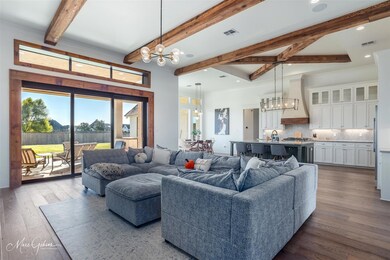Living room featuring beam ceiling, a notable chan