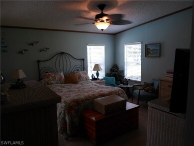 Master bedroom has sliding glass doors to pool.