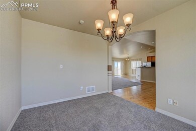 Formal DR  with light carpet, vaulted ceiling, and
