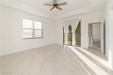 Tiled spare room with a raised ceiling and ceiling