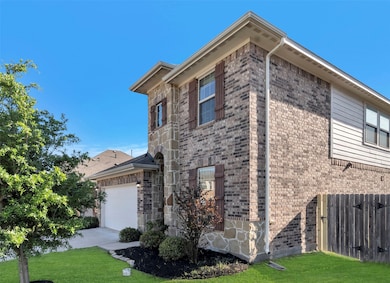 This two-story brick and stone home features a cle