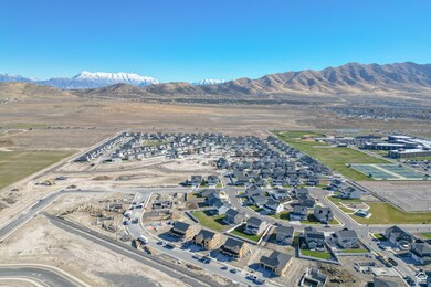 Aerial overview of property's location featuring nearby suburban area and a mountain backdrop