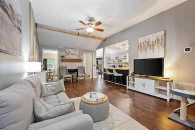 Living room with a ceiling fan, wood finished flo