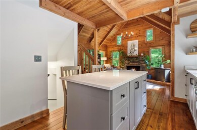 Kitchen featuring a kitchen island, dark hardwood 