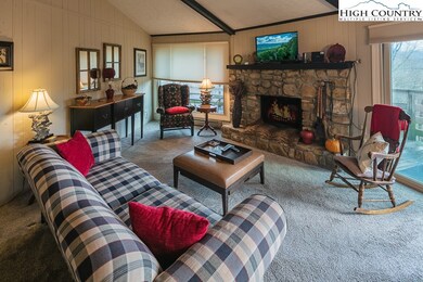 Cozy living room with vaulted ceilings and stone f