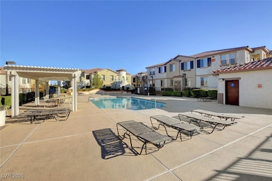 Community pool with a residential view, a pergola,