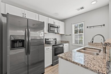Kitchen with sink, stainless steel appliances, whi