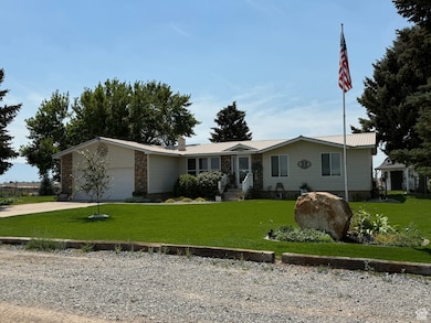 Ranch-style house with a chimney, an attached garage, concrete driveway, and a front yard