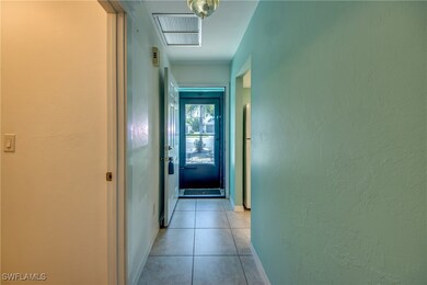 Hallway featuring light tile patterned flooring, b