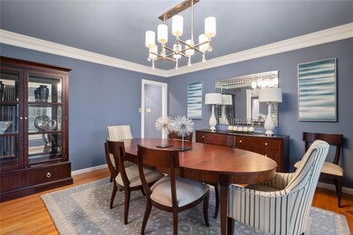Dining room with hardwood flooring, crown molding,