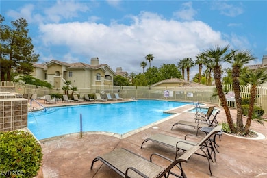 Pool featuring a patio and fence