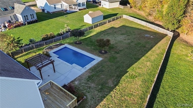View of swimming pool with a yard