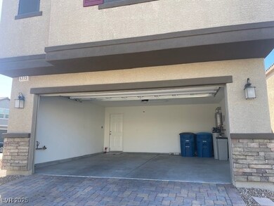 Garage featuring decorative driveway