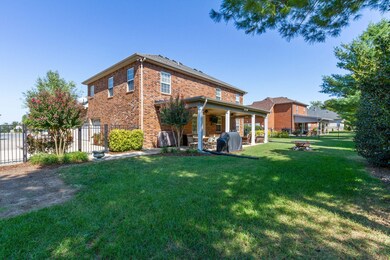 Beautiful landscaping extends to the amazing backyard that is perfect for entertaining