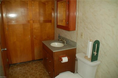 Bathroom featuring toilet, oversized vanity, and tile flooring