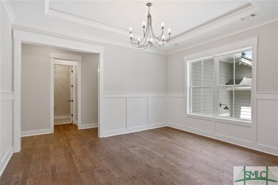 Custom wainscoting and cove tray ceiling add the p