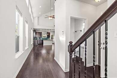 Entryway with high vaulted ceiling, dark wood-sty
