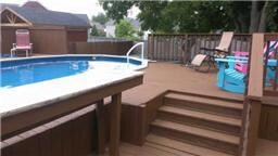 DECK SURROUNDING POOL WITH LOUNGING AREA!