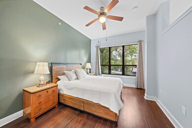 The inviting primary bedroom features warm wood fl
