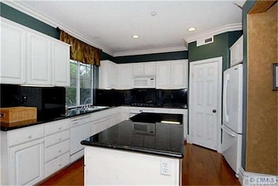 Kitchen has granite counters and large island